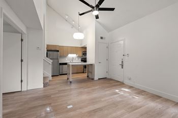 Modern kitchen with wooden floor and fan